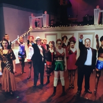 the company singing “Tomorrow belongs to Me” with Jo Lloyd as Fraulein Kost